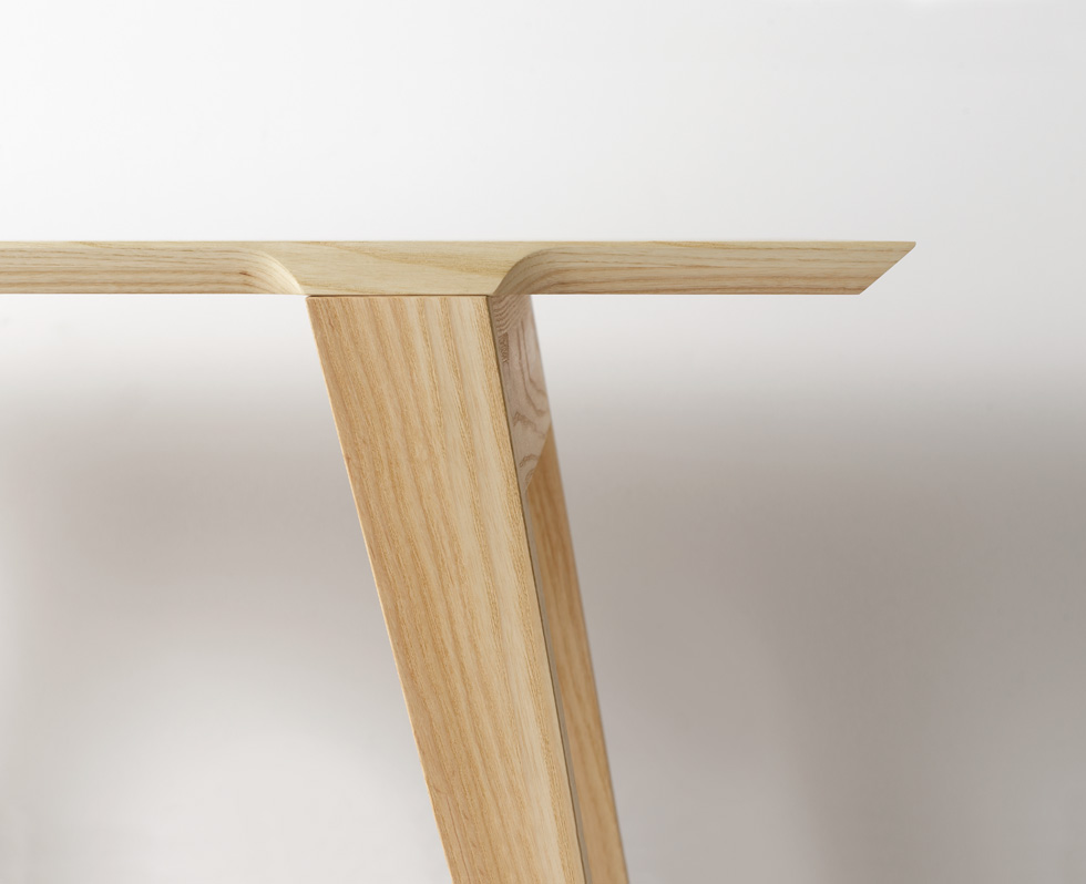 A wooden bench with simple rectangular top and angled legs