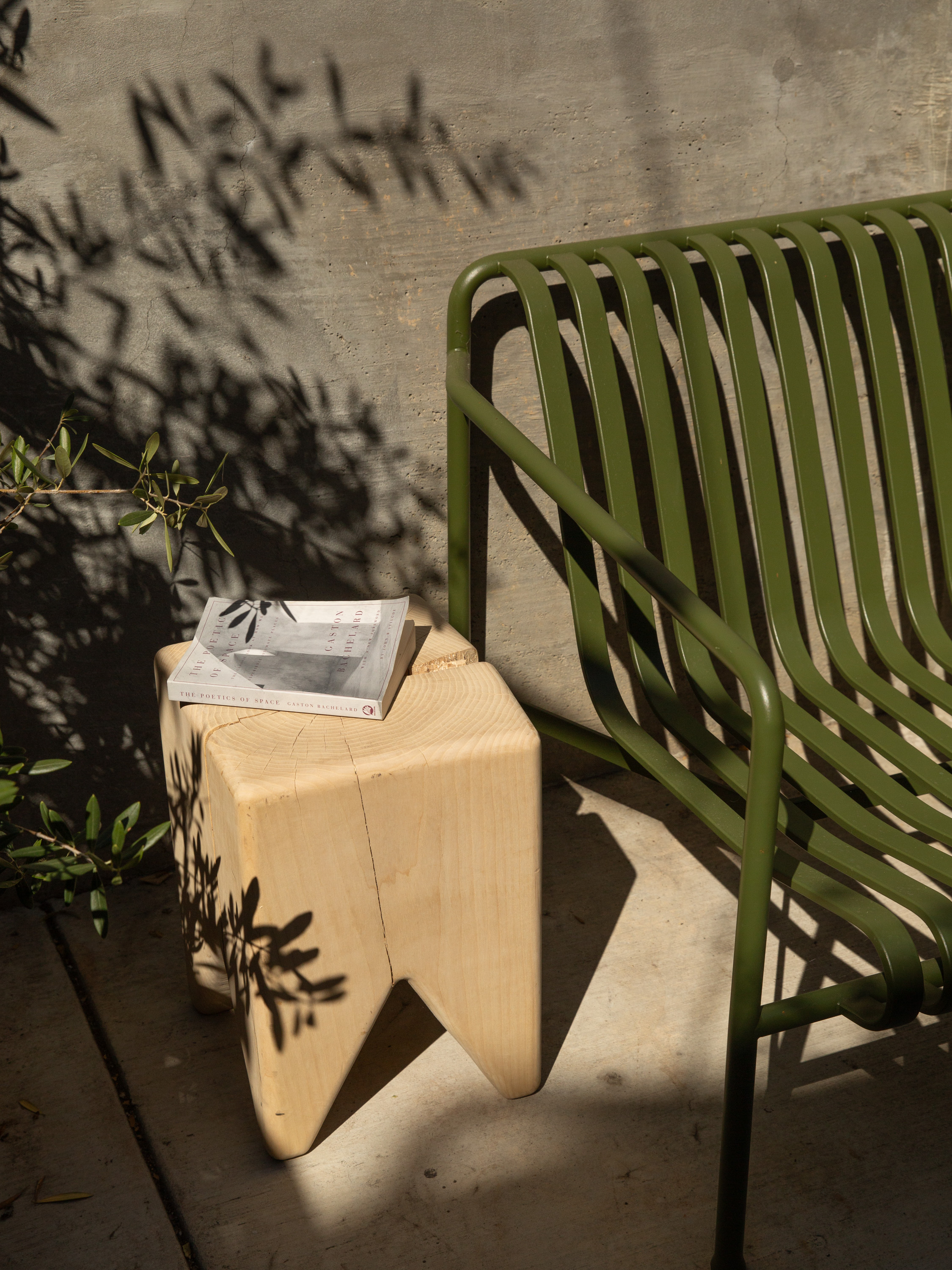 A large wooden stool, a small log-stump, and a smaller wooden stool aligned in a row.