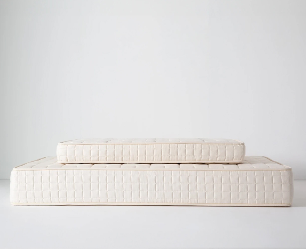 Close-up of mattress edge with white quilted cover showing stitching and texture