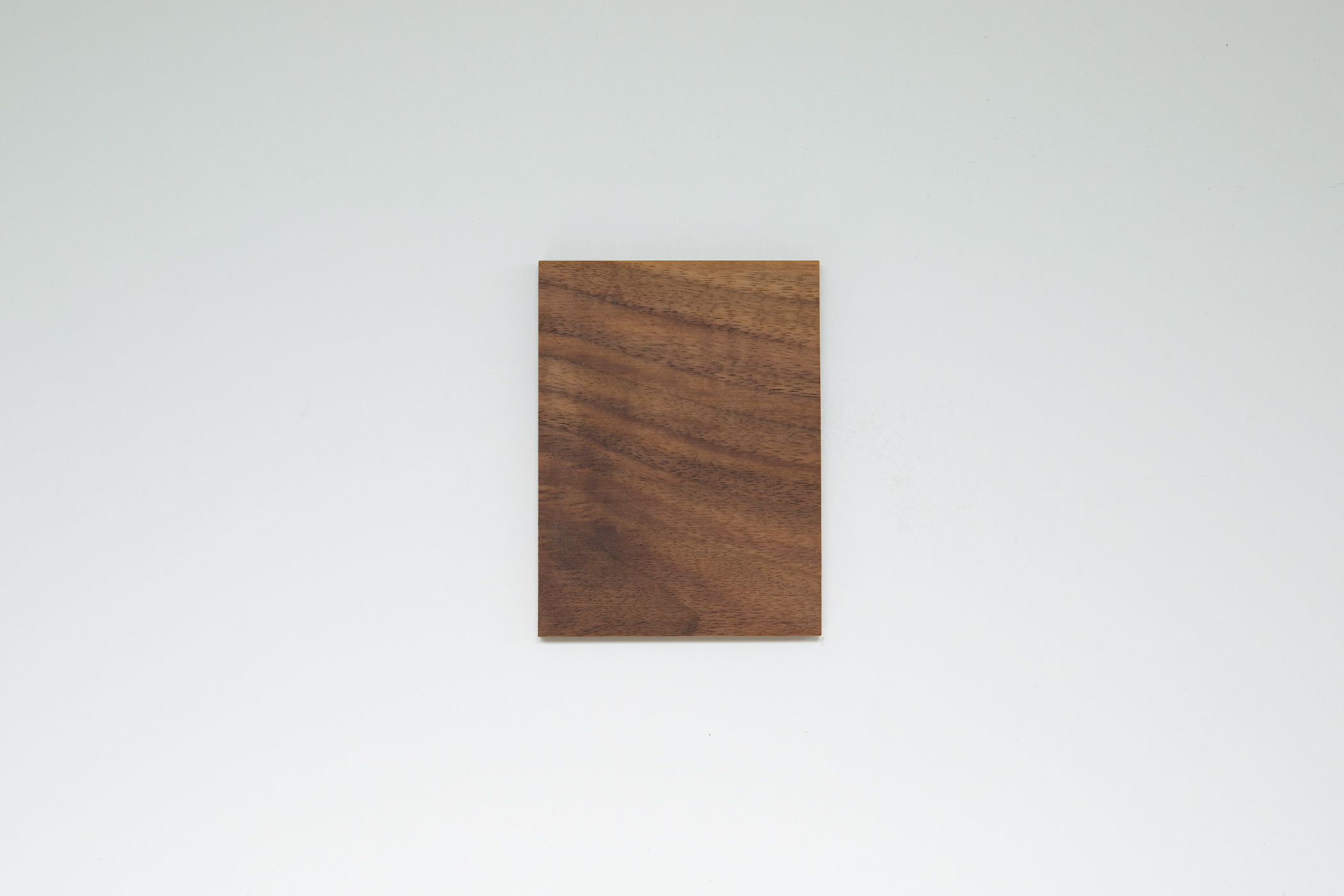 Close-up of the table top edge overhanging, showing wood grain and leg joint detail.