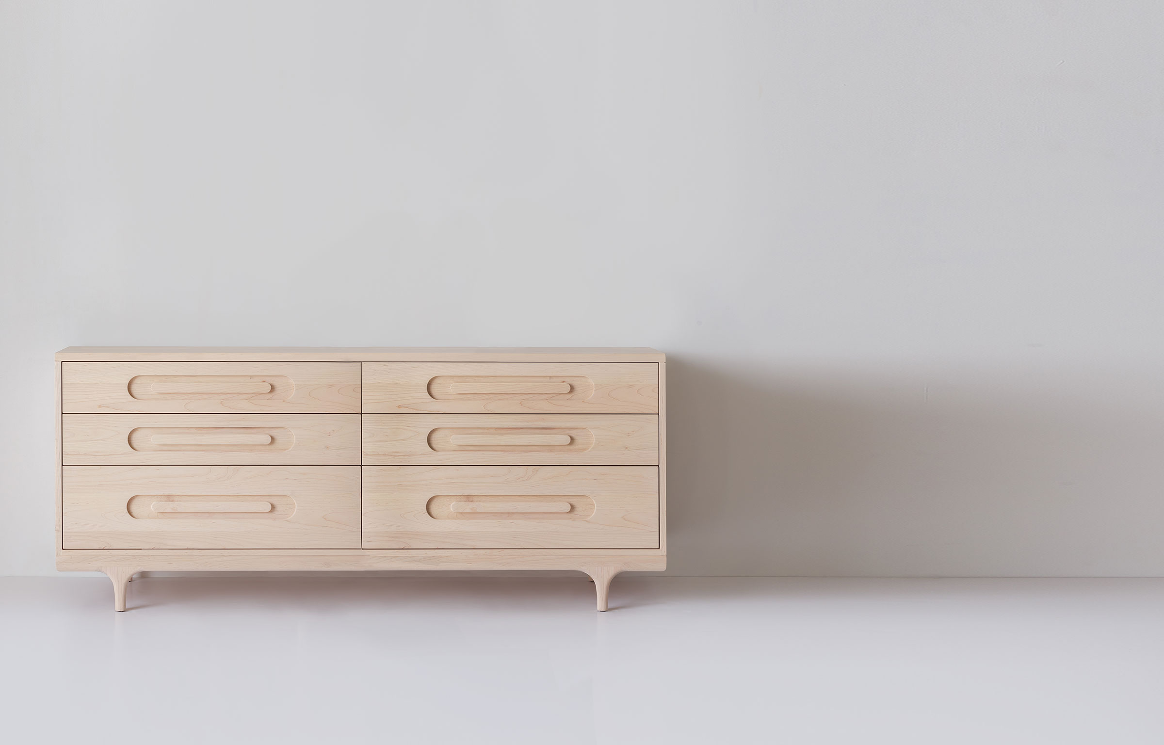 Light wood double dresser with six drawers, side view
