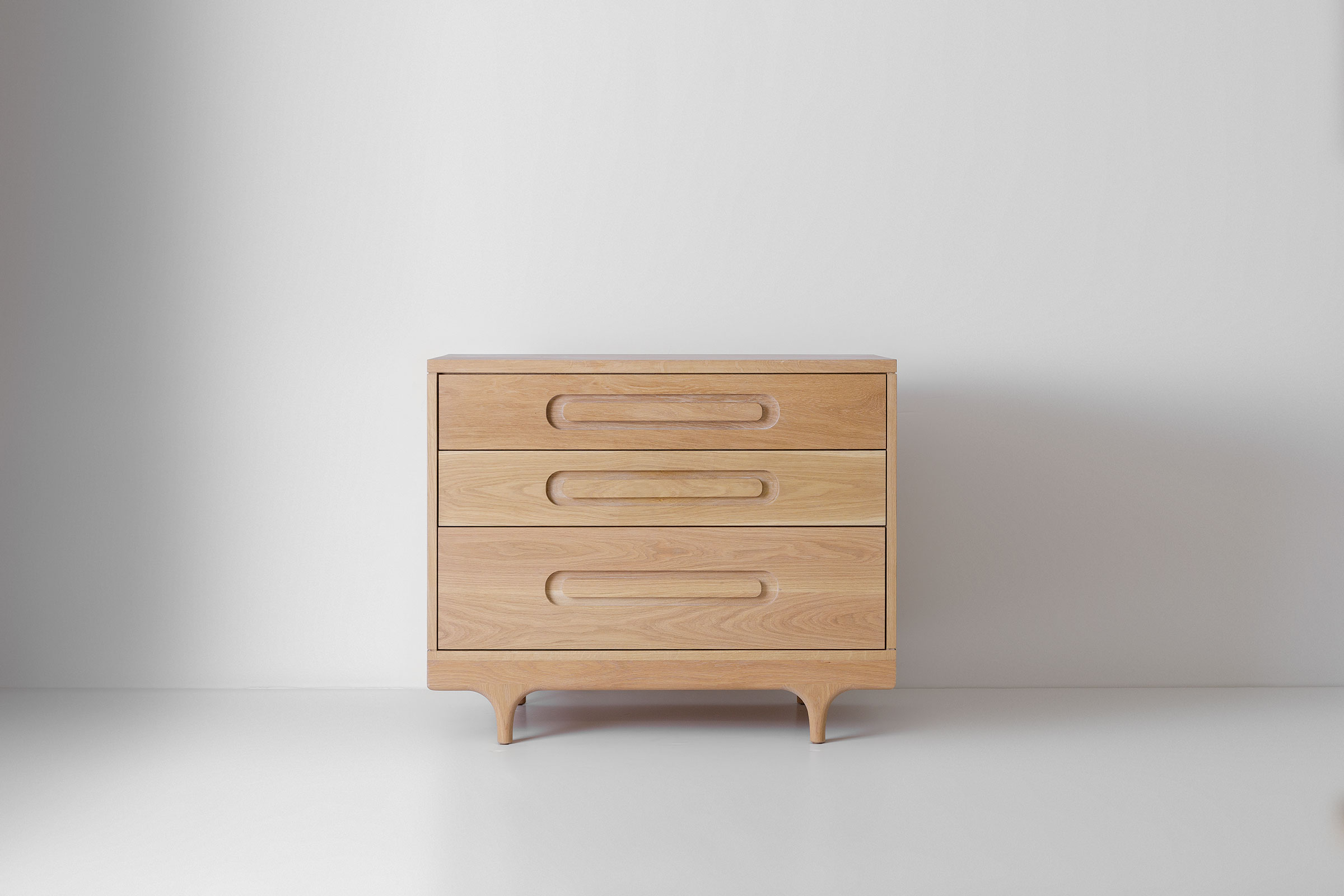 Caravan Dresser White Oak front view with three drawers and rounded feet