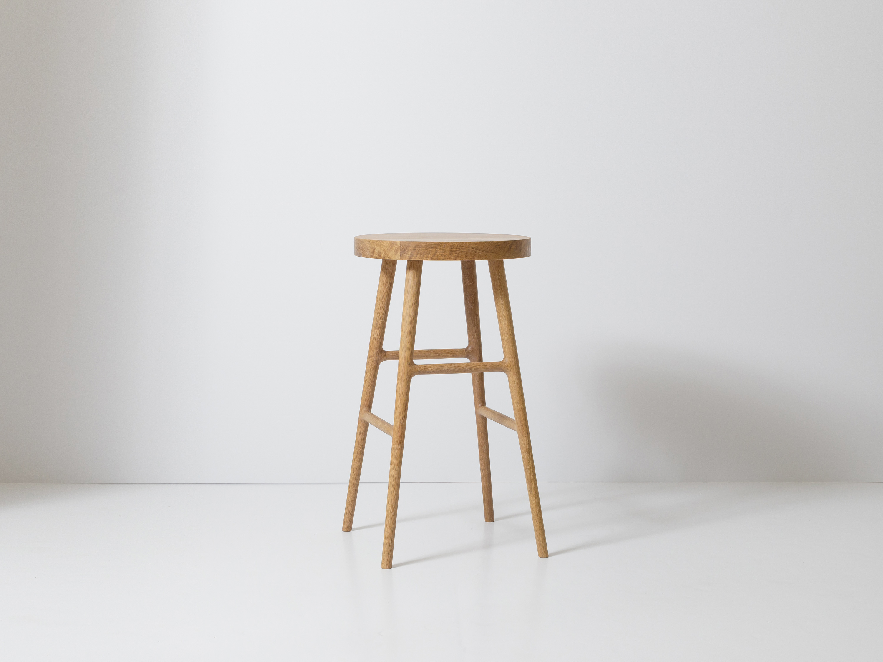 Close-up of pink kitchen island and stool in foreground