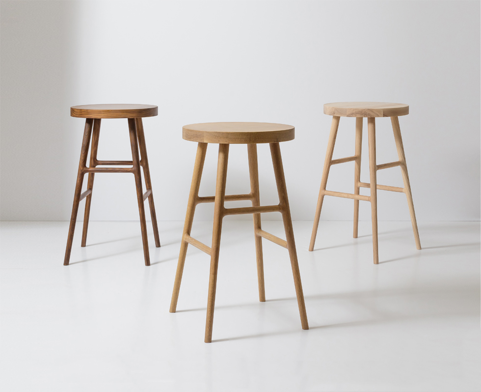 Close-up of the stool legs and joints showing wood grain and joinery