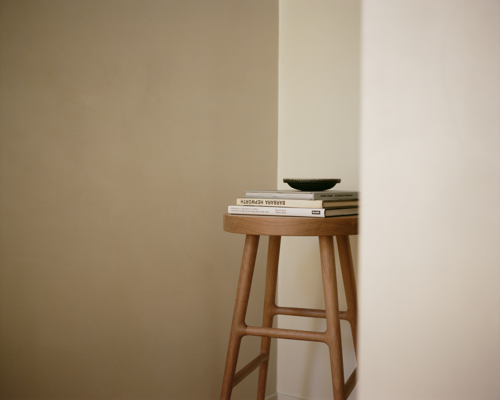 Close-up of stool leg and crossbar connection with wood grain