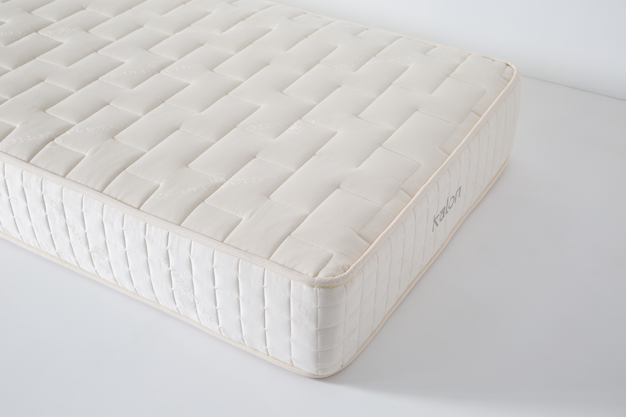 Close-up of quilted pattern on a beige mattress cover