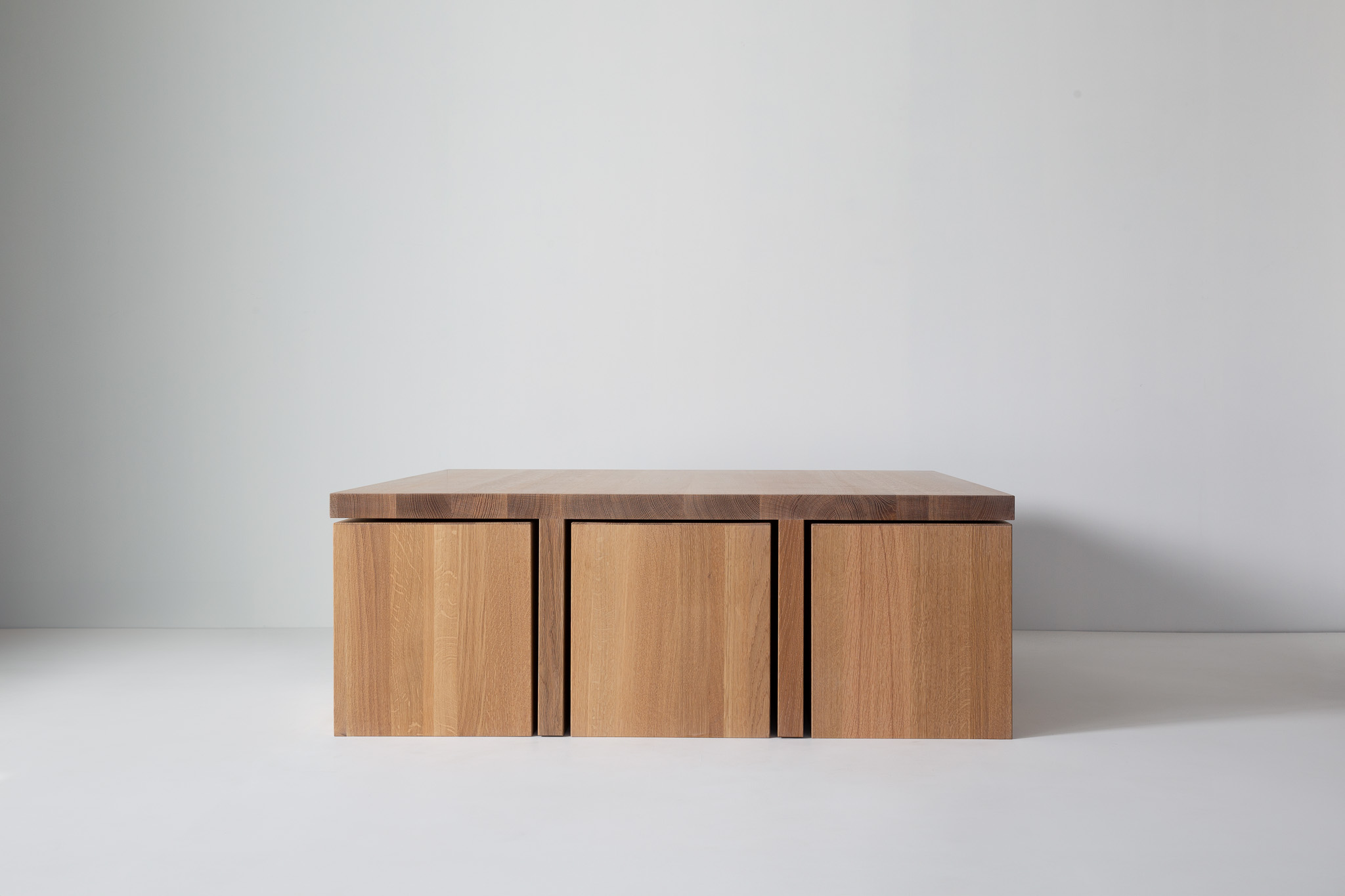 A wooden tabletop with sturdy legs, front view showing plank texture
