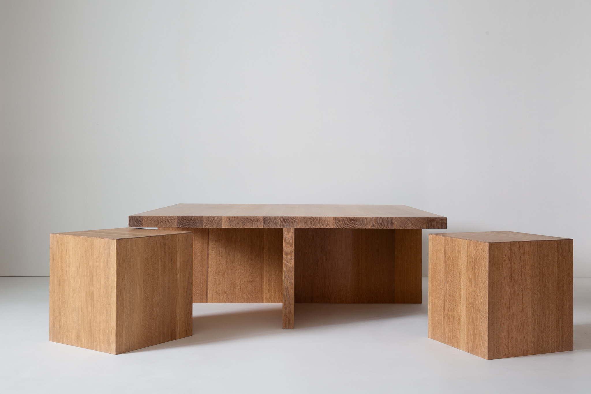 A wider view of the table with a pale wall backdrop; tabletop and base visible.
