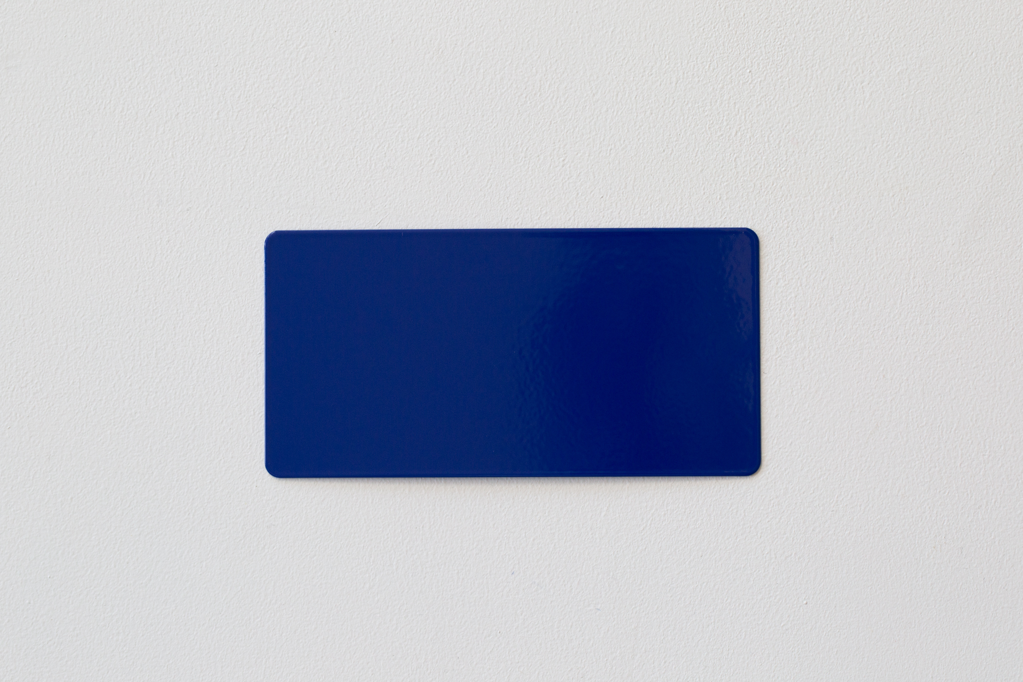 Blue rectangular card with rounded corners on white textured background.